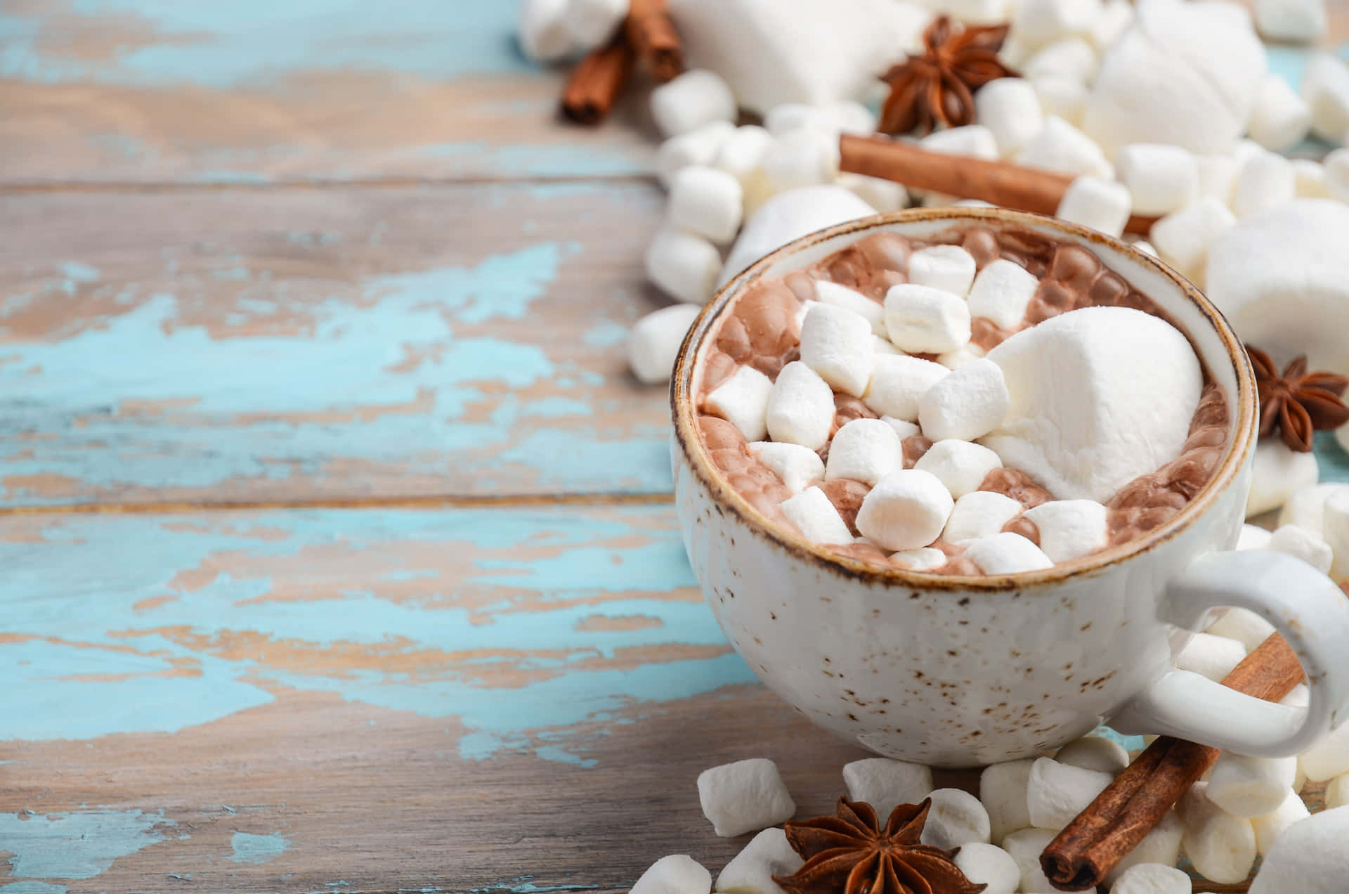A cozy mug of steaming hot chocolate with marshmallows Wallpaper