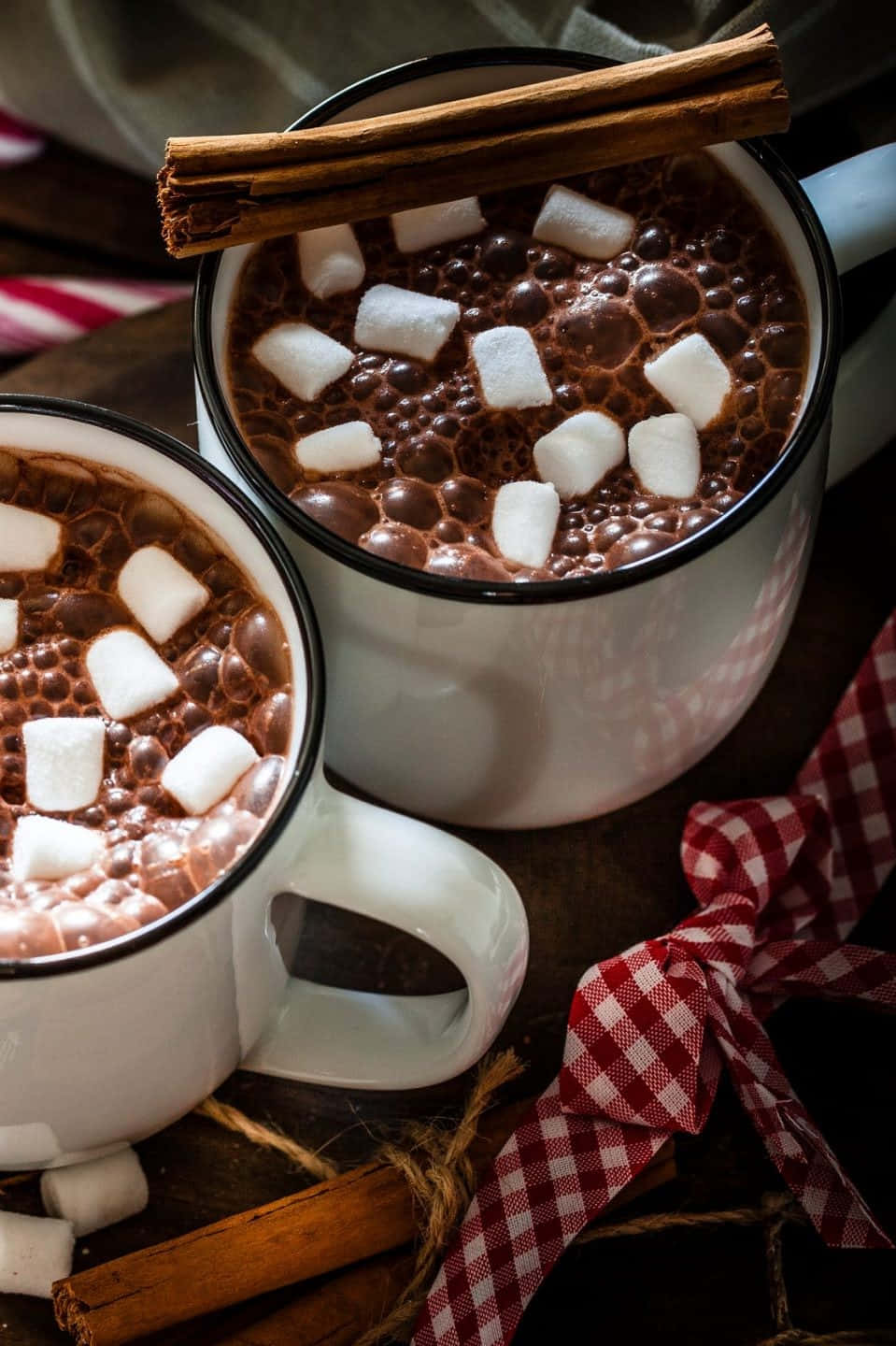 Delicious Hot Chocolate with Whipped Cream and Cinnamon Sticks Wallpaper