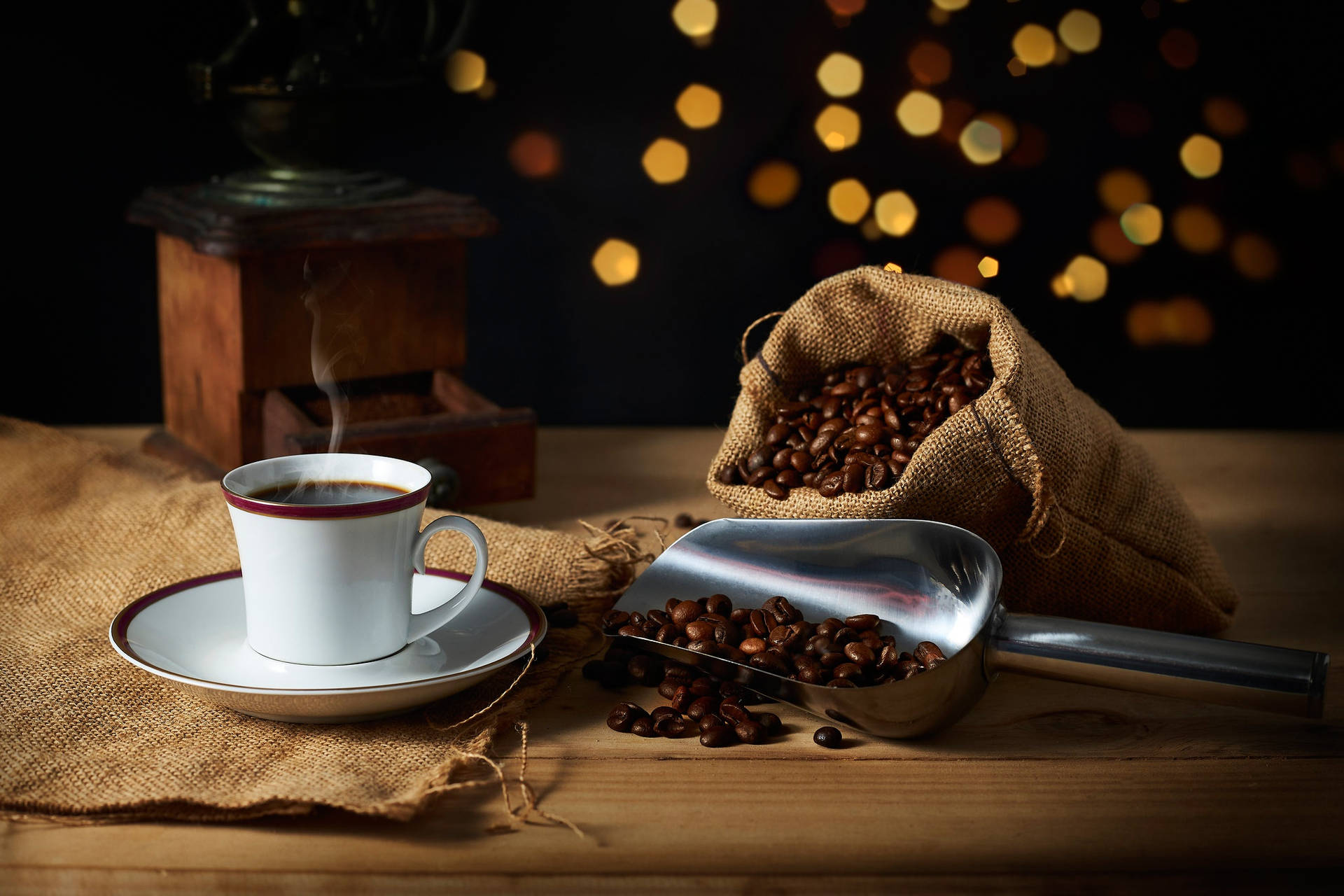 Hot Coffee In A Coffee Cup With Coffee Beans Wallpaper
