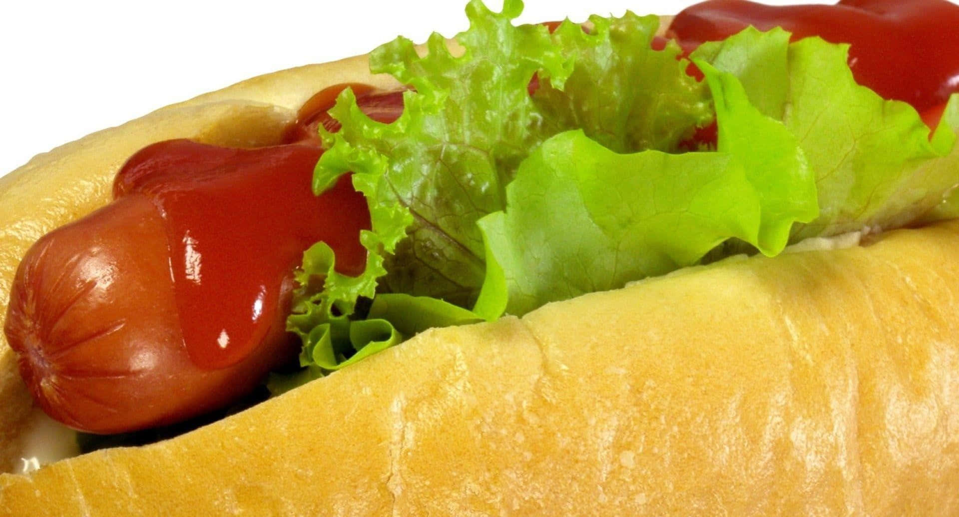 A Hot Dog With Ketchup And Lettuce