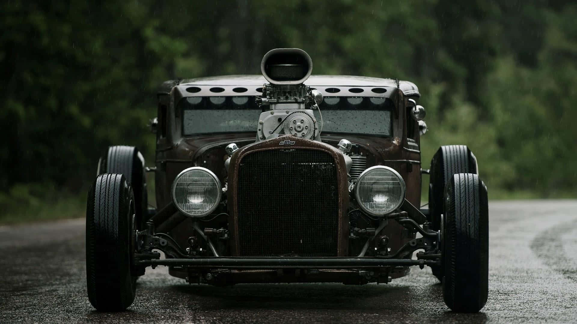 An Old Fashioned Car Driving Down A Road Wallpaper