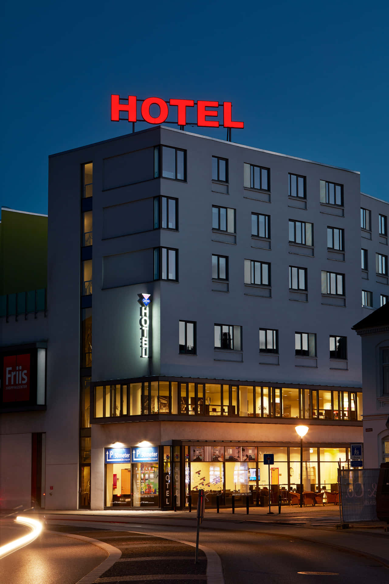 A Hotel Building With A Sign