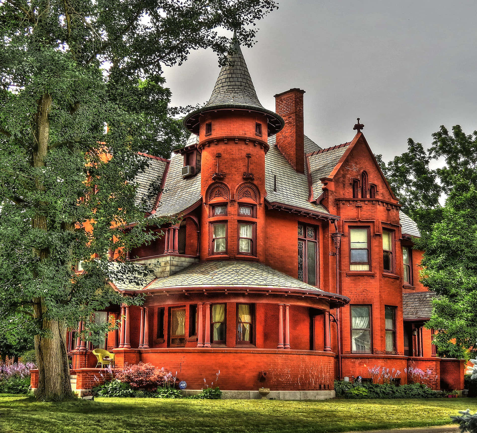 A Red Victorian House With A Turret