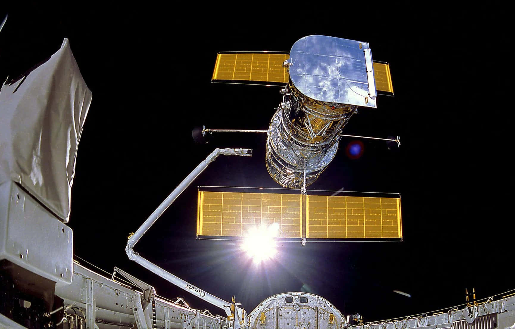 Breathtaking Image of the Hubble Space Telescope Exploring the Cosmos Wallpaper