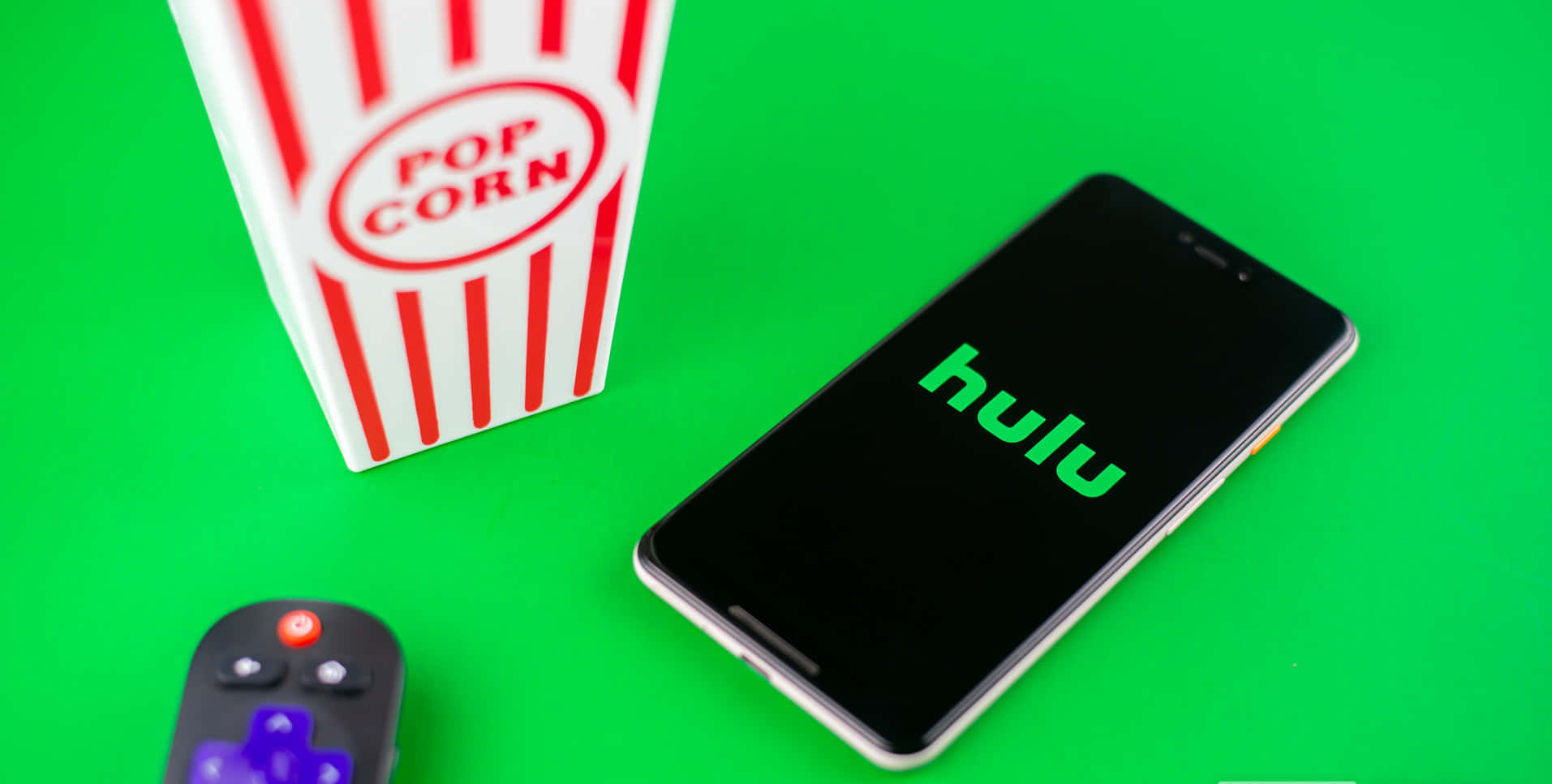Bright colors of the Hulu logo on an orange and yellow gradient background