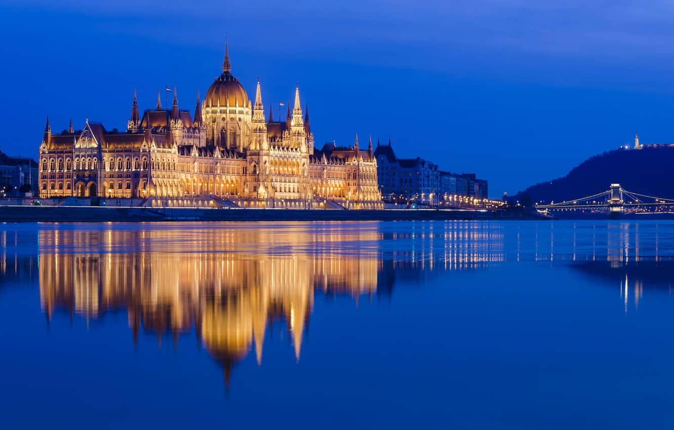 Stunning Night Reflection of the Hungarian Parliament Buildings Wallpaper