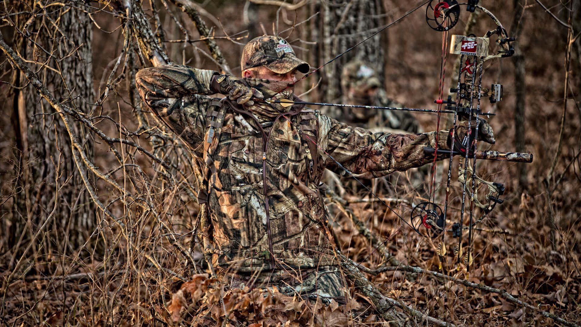 Man In Hunting Camo On Dried Leaves Wallpaper