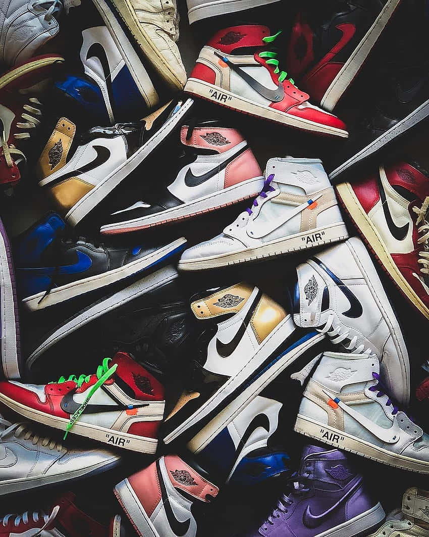 A Group Of Sneakers Arranged In A Pile Wallpaper
