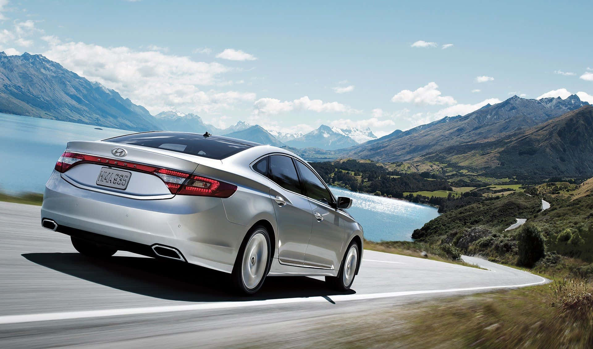 Sleek Hyundai Azera in motion on a scenic route Wallpaper