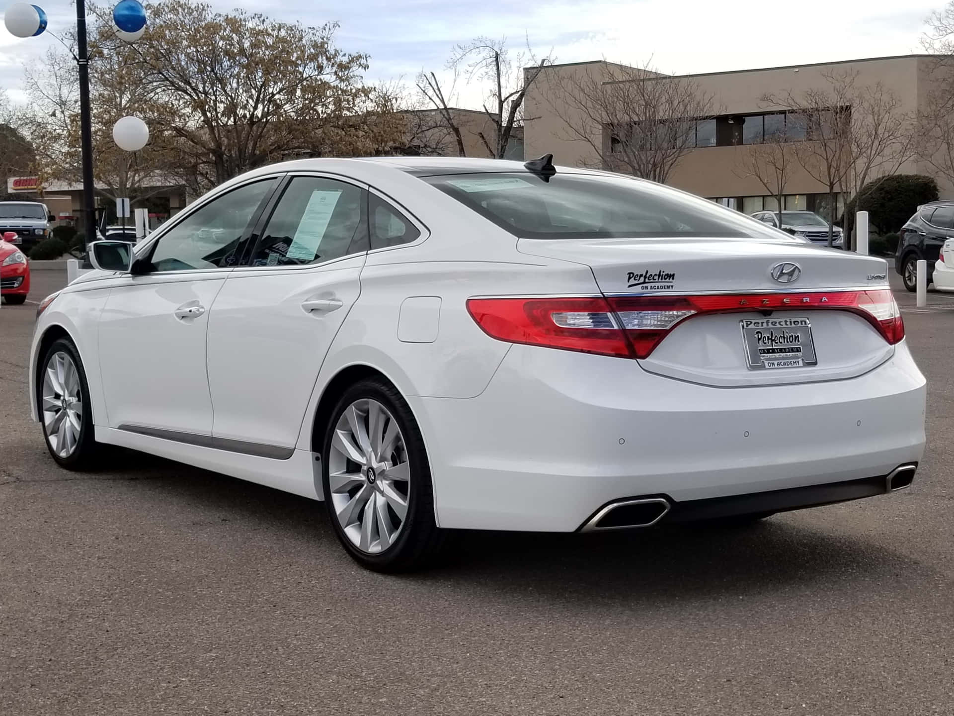 Sleek Hyundai Azera cruising on a scenic road Wallpaper