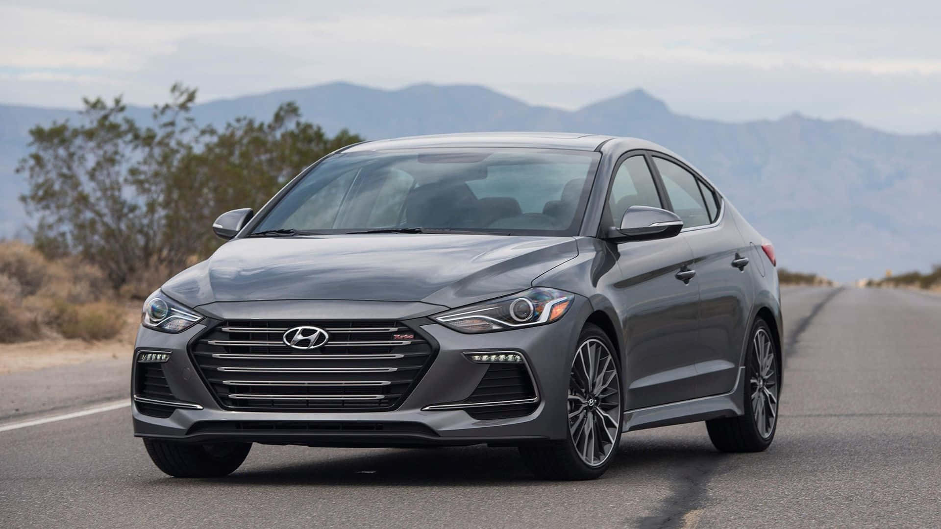 Sleek New Hyundai Elantra on a Scenic Highway Wallpaper