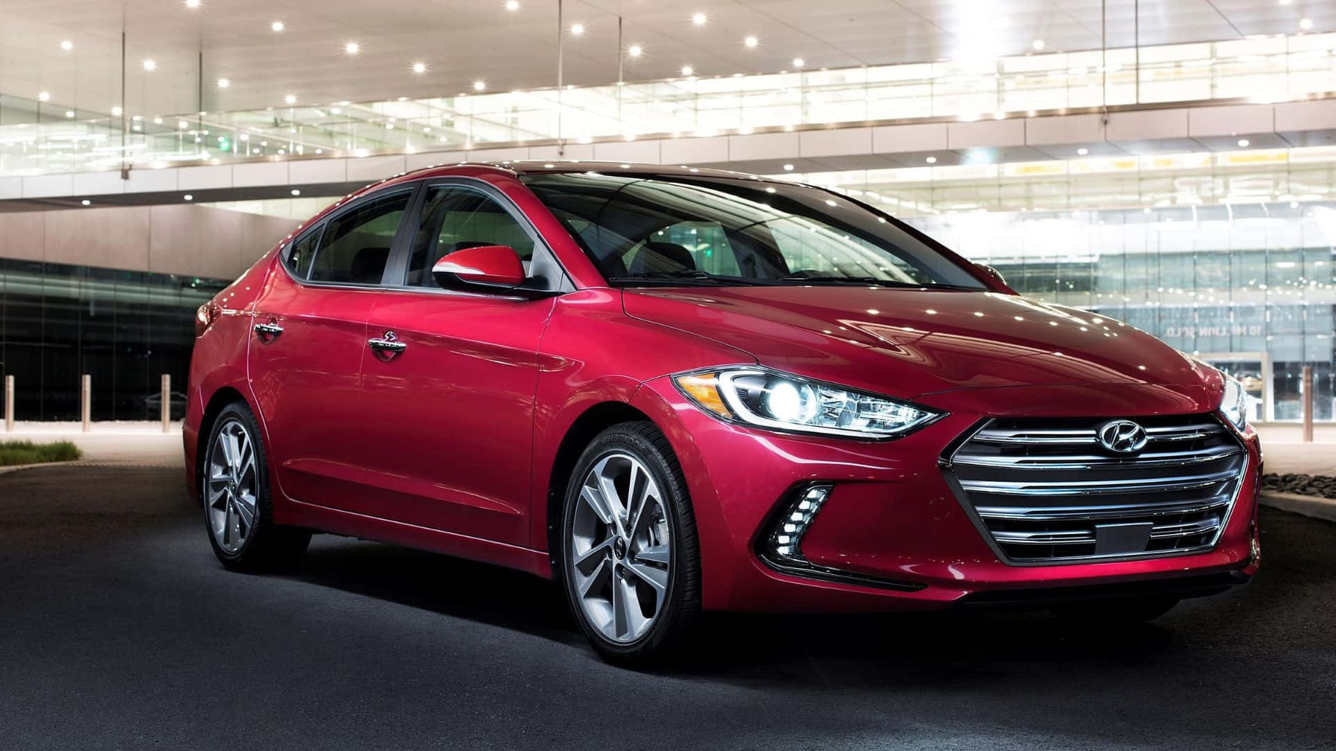 Sleek Hyundai Elantra in Vibrant City Setting Wallpaper