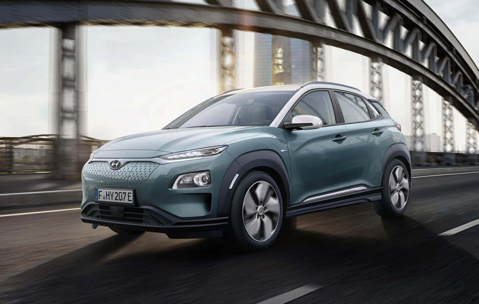 Hyundai Kona cruising through a scenic landscape Wallpaper