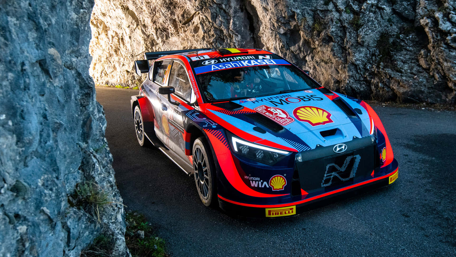 Hyundai Rally Car Speeding Through Mountain Pass.jpg Wallpaper