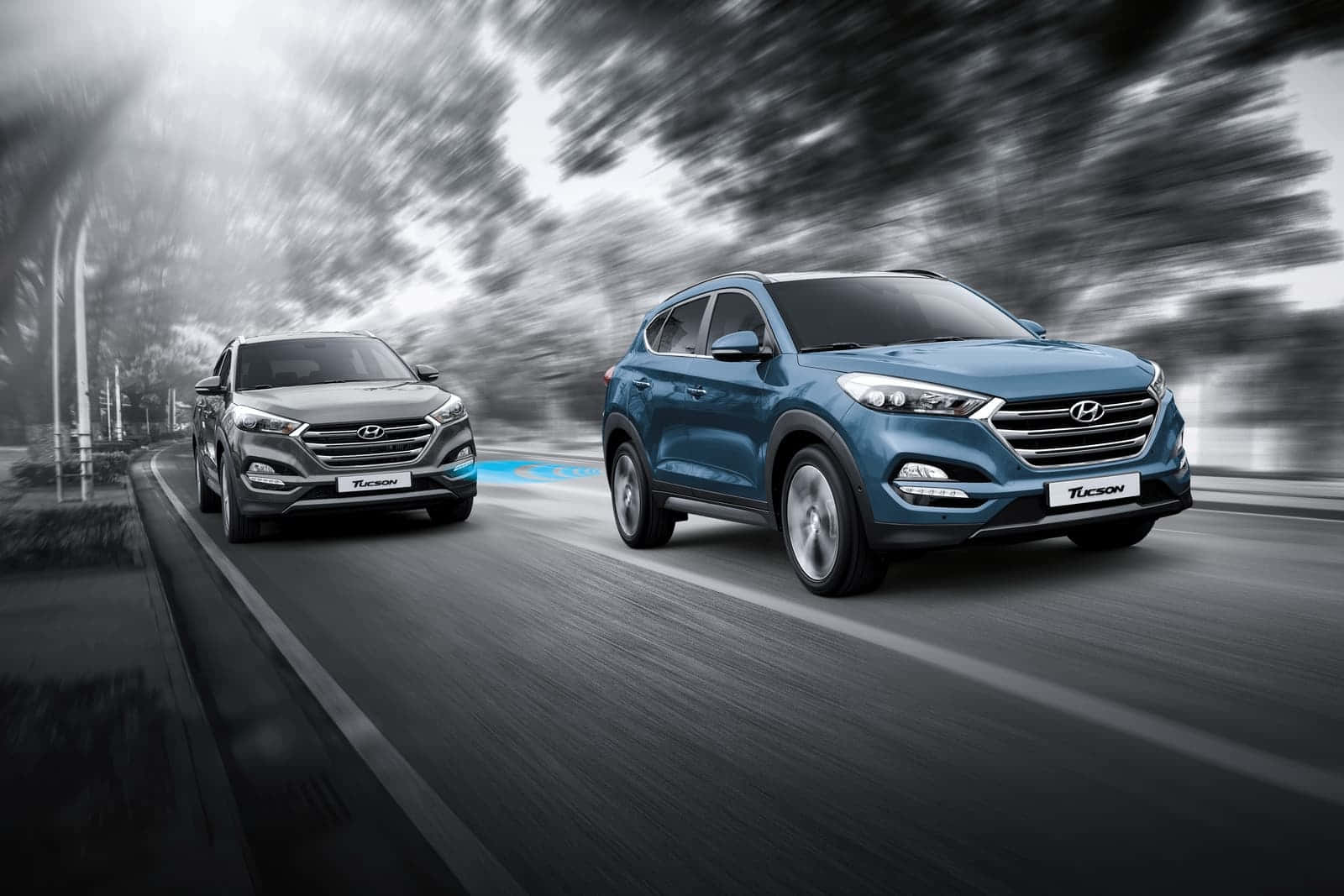 Hyundai Tucson cruising on the road Wallpaper