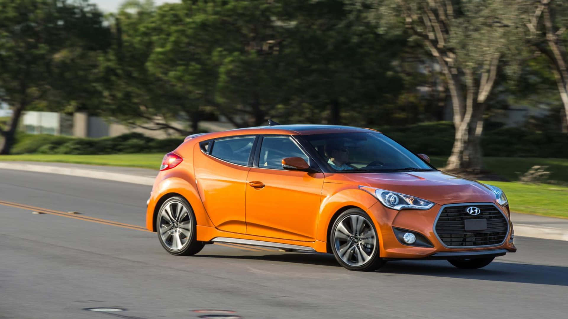 Sleek Hyundai Veloster in a Scenic Cityscape Wallpaper