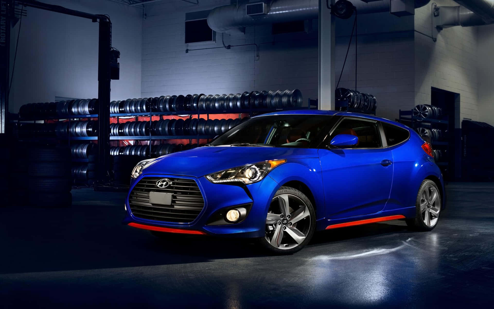 A Sleek Red Hyundai Veloster on the Road Wallpaper