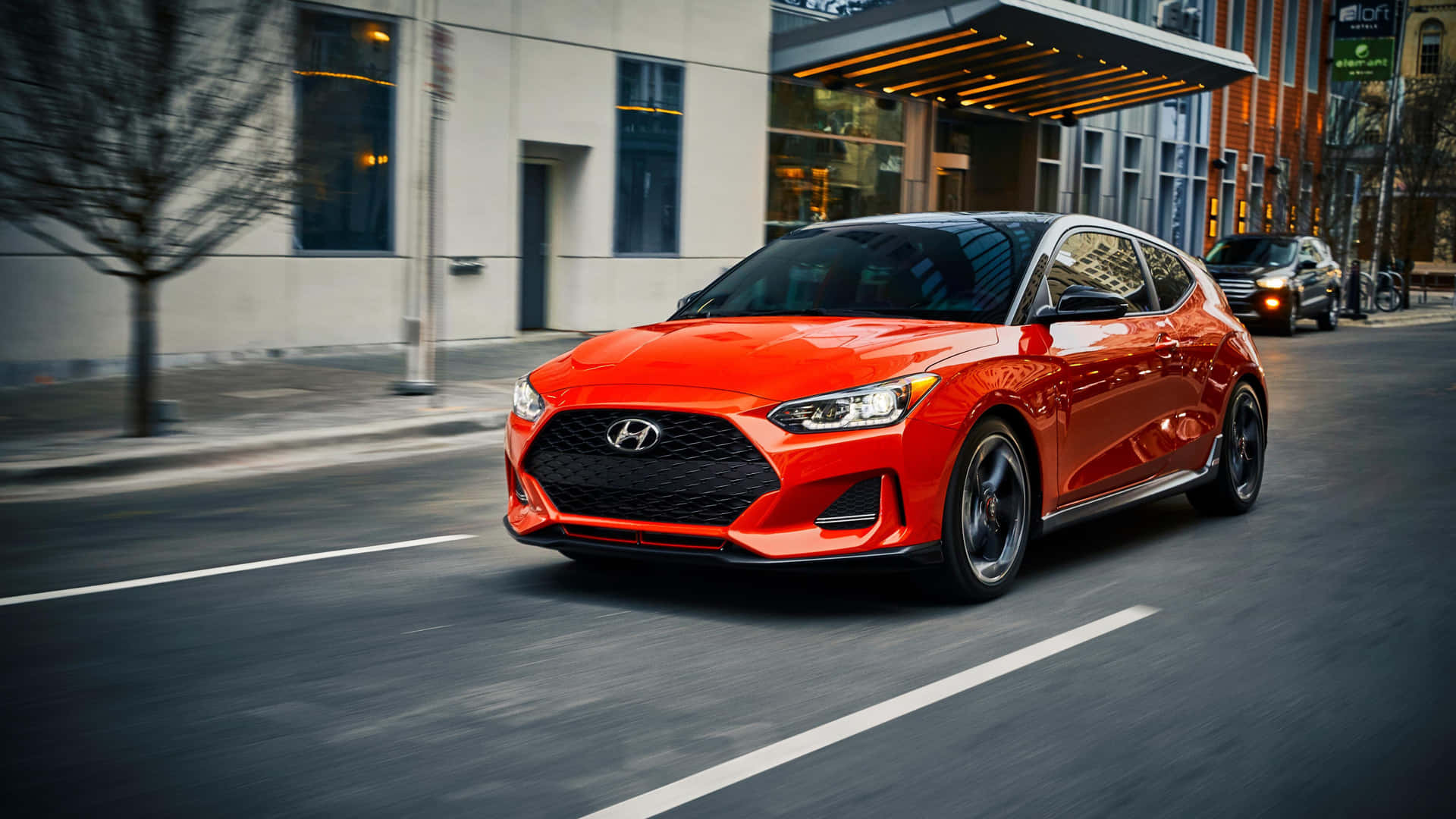 Sleek Hyundai Veloster Sports Coupe on the Open Road Wallpaper
