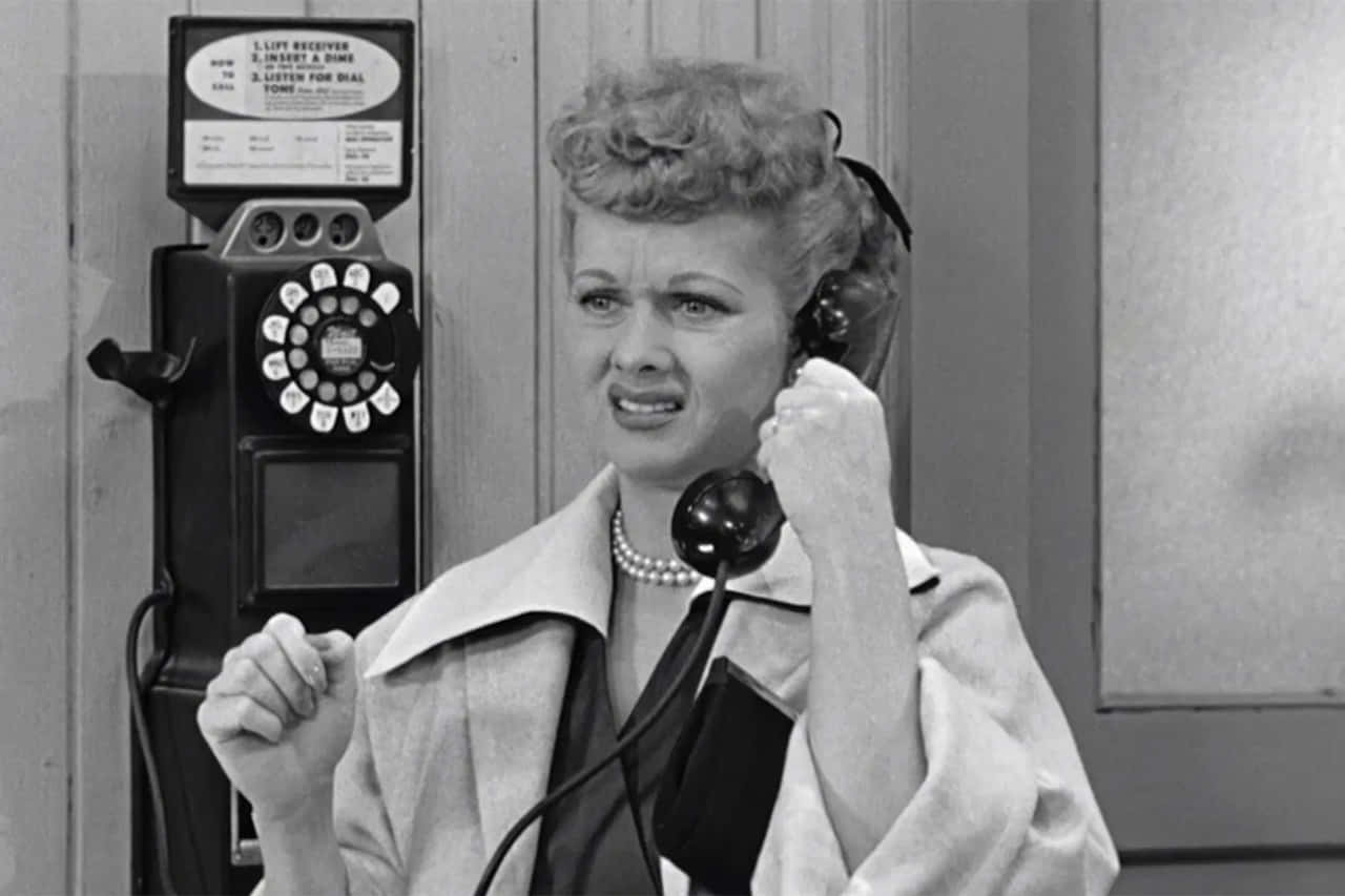 A Woman Talking On A Telephone Wallpaper