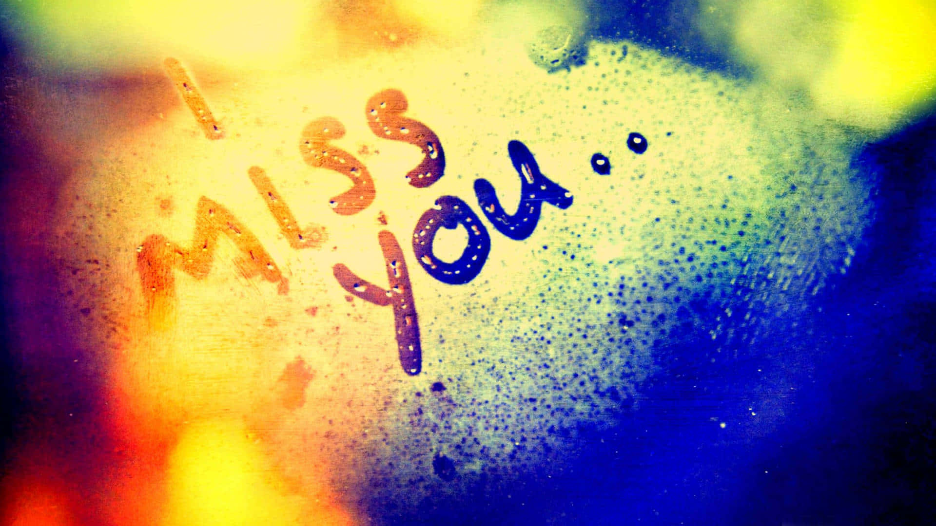 A heartfelt message of "I Miss You" on a foggy window
