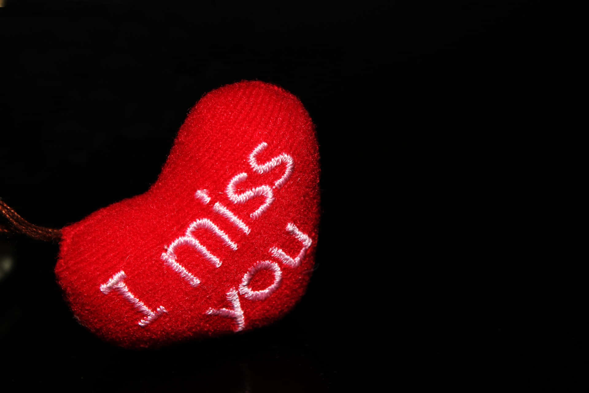 A heartfelt 'I Miss You' message written in sand at a beach