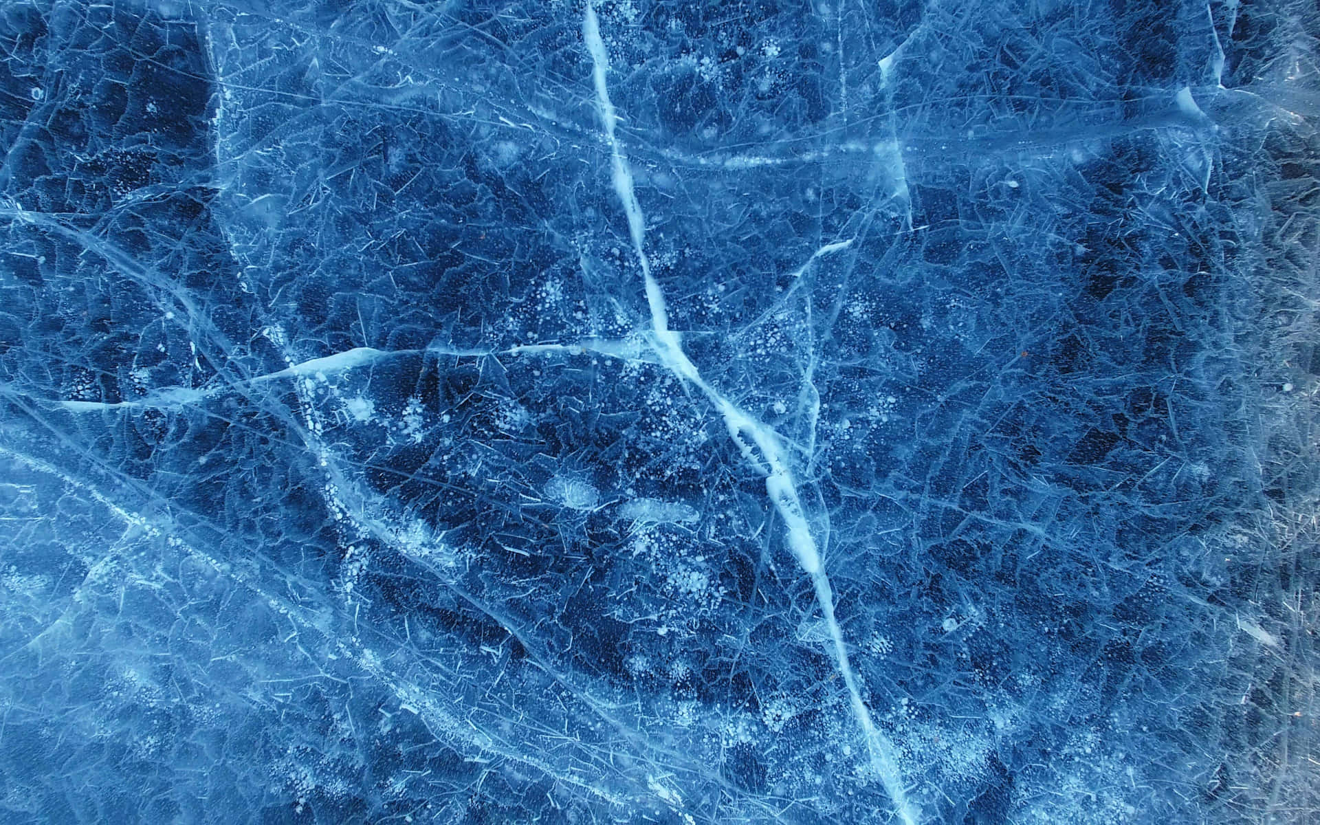 The deep blue shades of ice take on an unforgettable majestic beauty Wallpaper