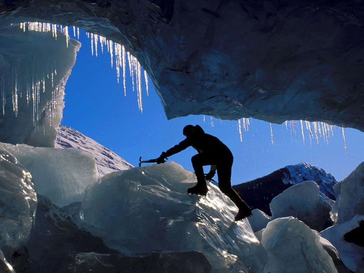 Ice Climber scaling a frozen waterfall Wallpaper