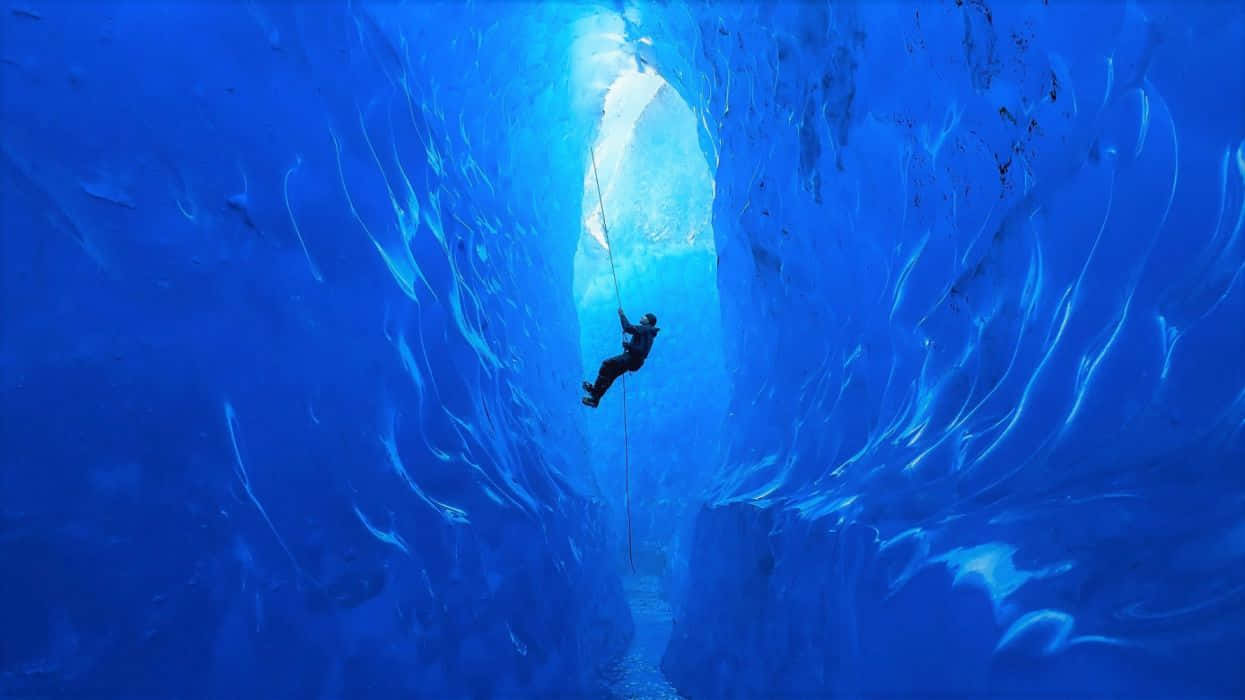 Captivating Adventure on the Icy Wall Wallpaper