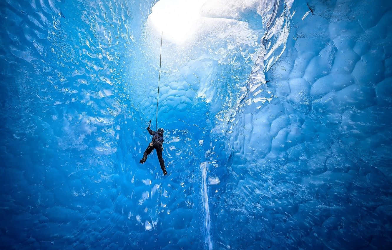 Passionate climber tackling a frozen waterfall Wallpaper