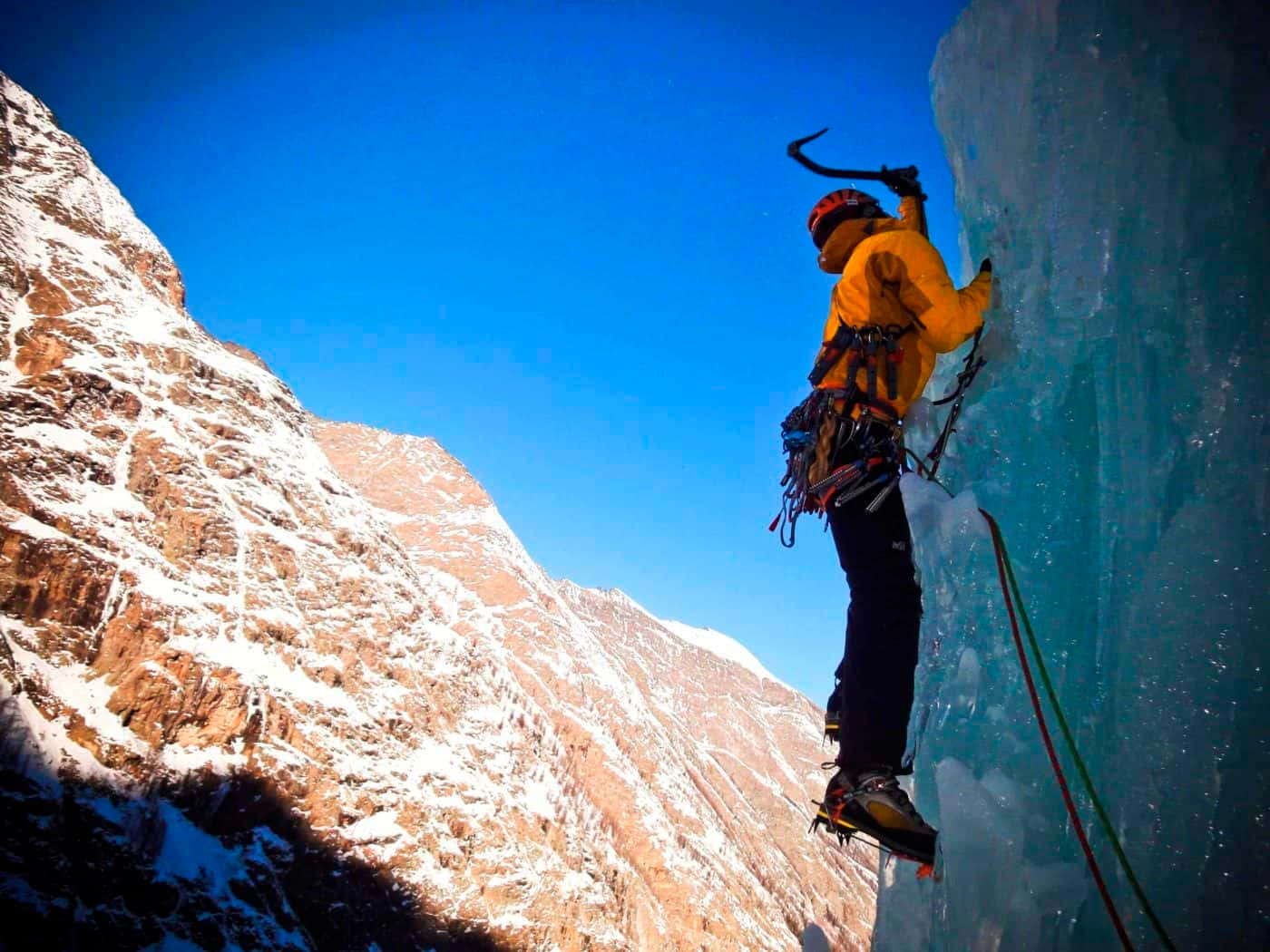 Climber Ascending a Frozen Waterfall Wallpaper