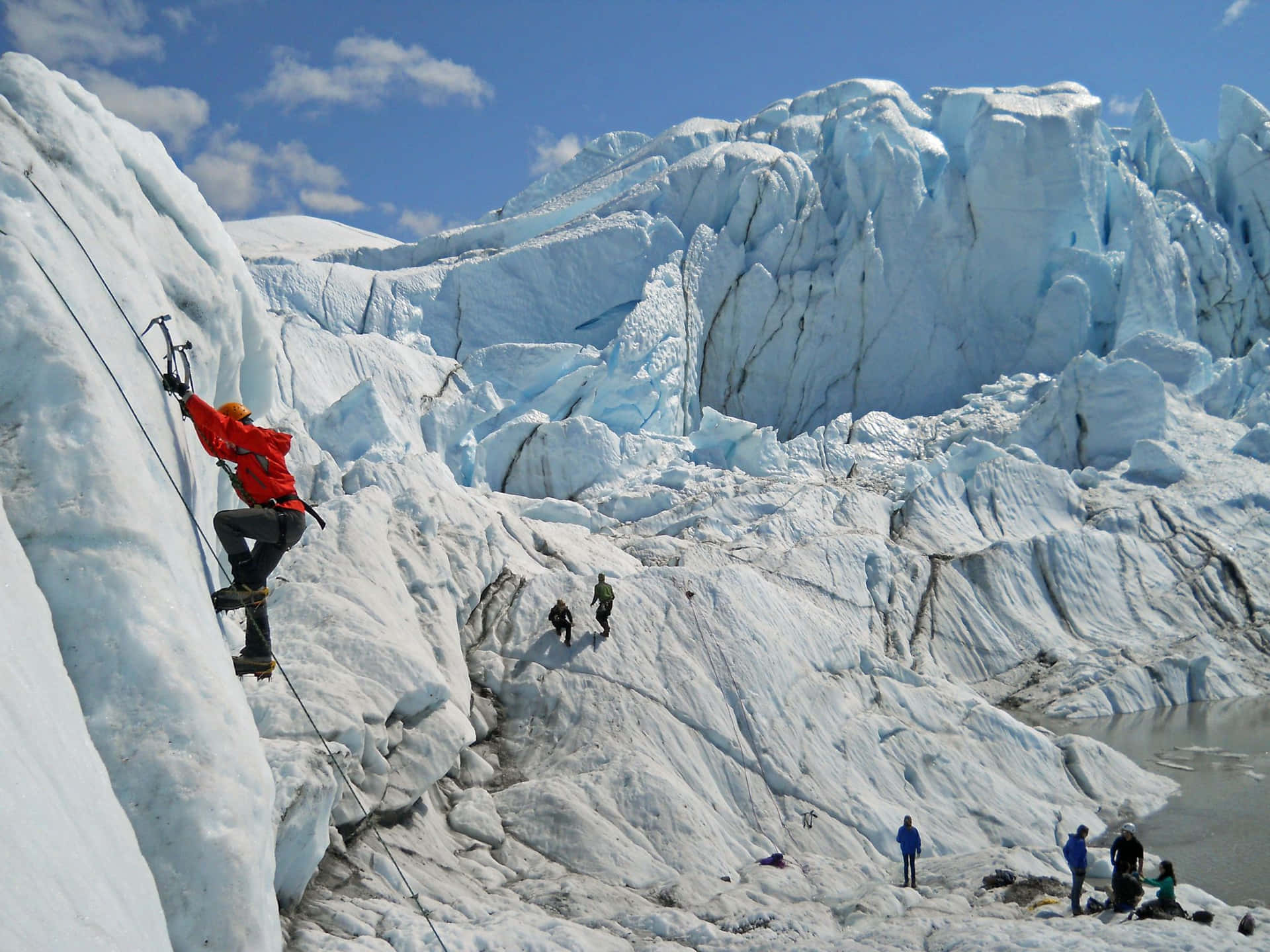 Ice climber ascending a frozen waterfall Wallpaper