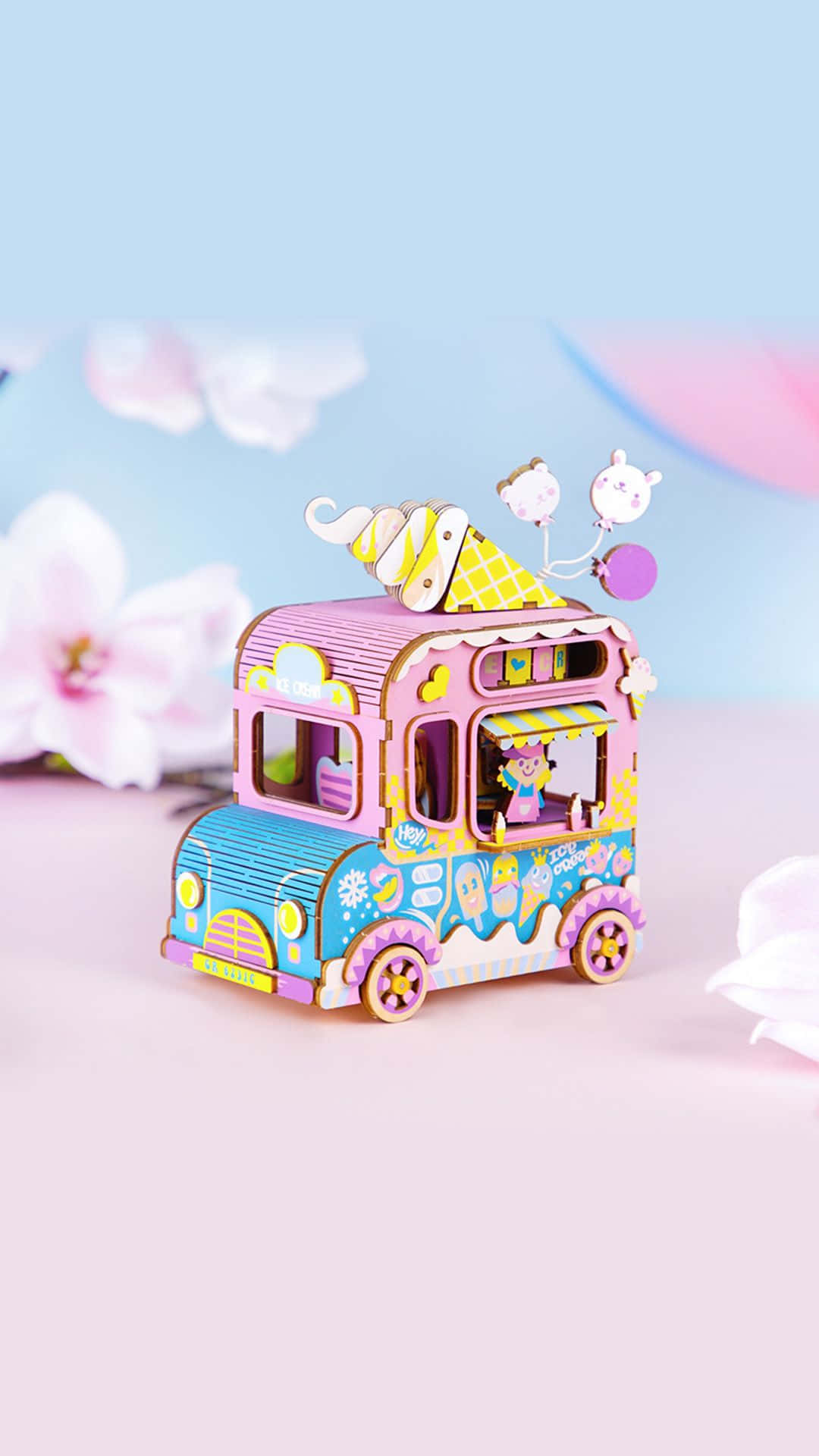 A Toy Ice Cream Truck With Flowers On It