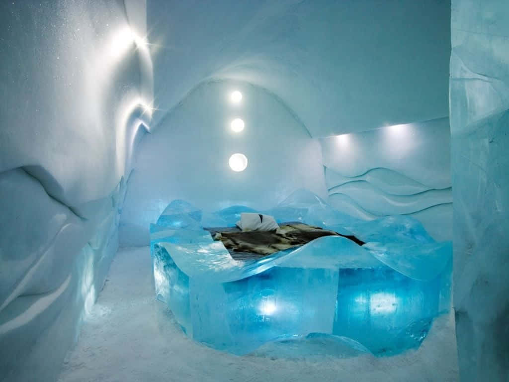 A Stunning Ice Hotel Suite with Intricate Ice Sculptures Wallpaper