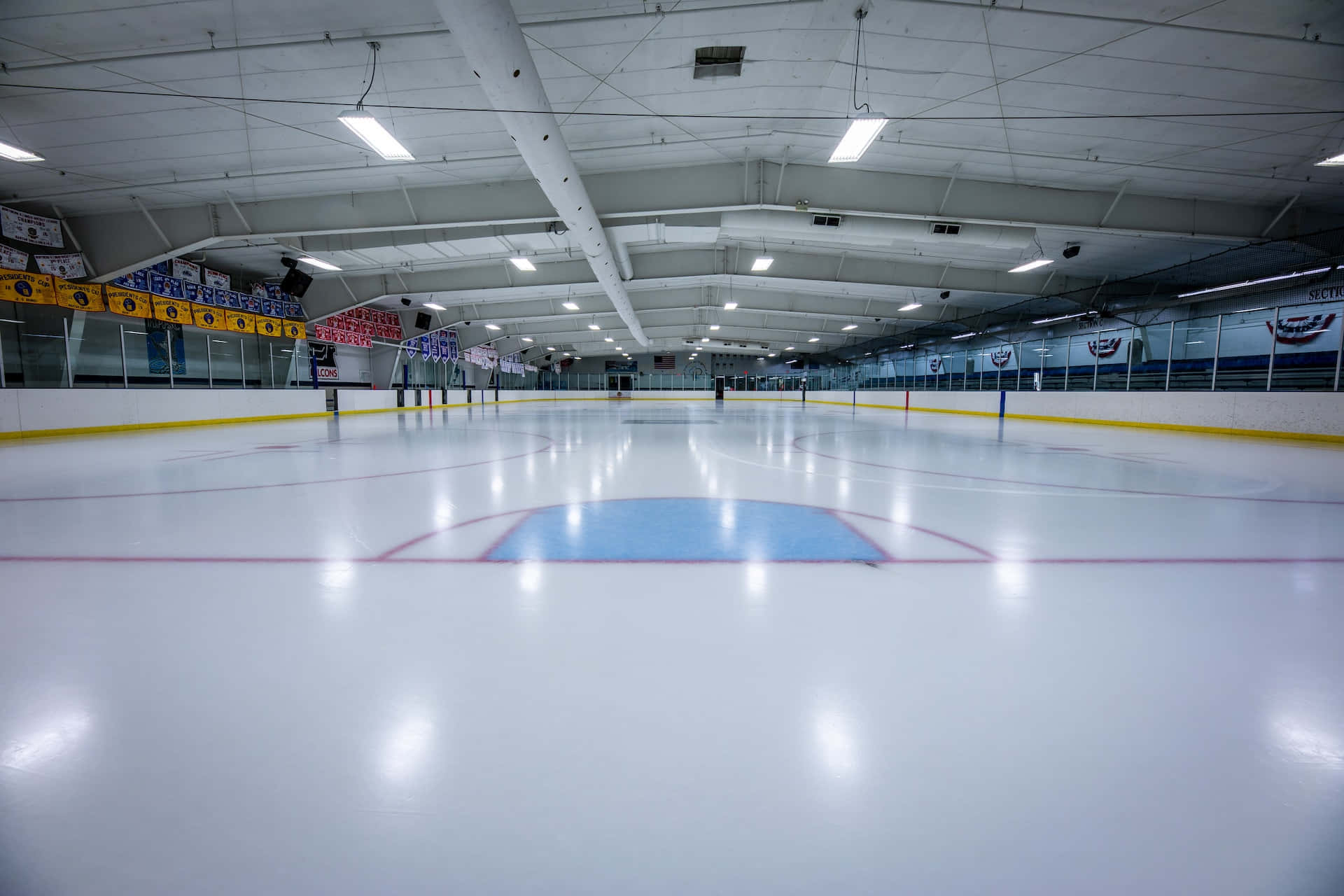 A Wide View of an Indoor Ice Rink Wallpaper