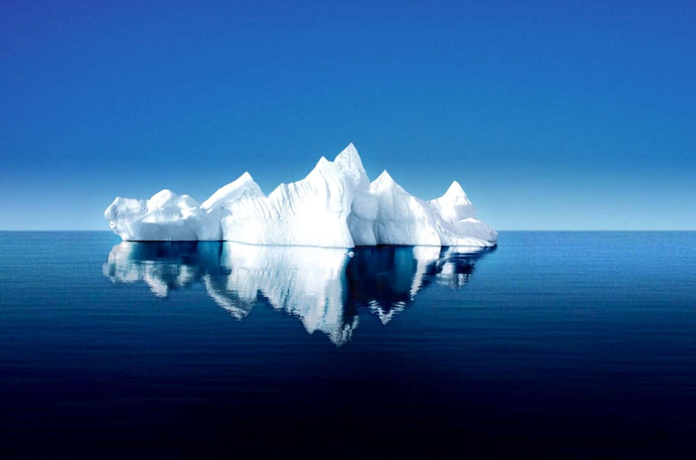 Majestic Iceberg Floating on Tranquil Waters Wallpaper