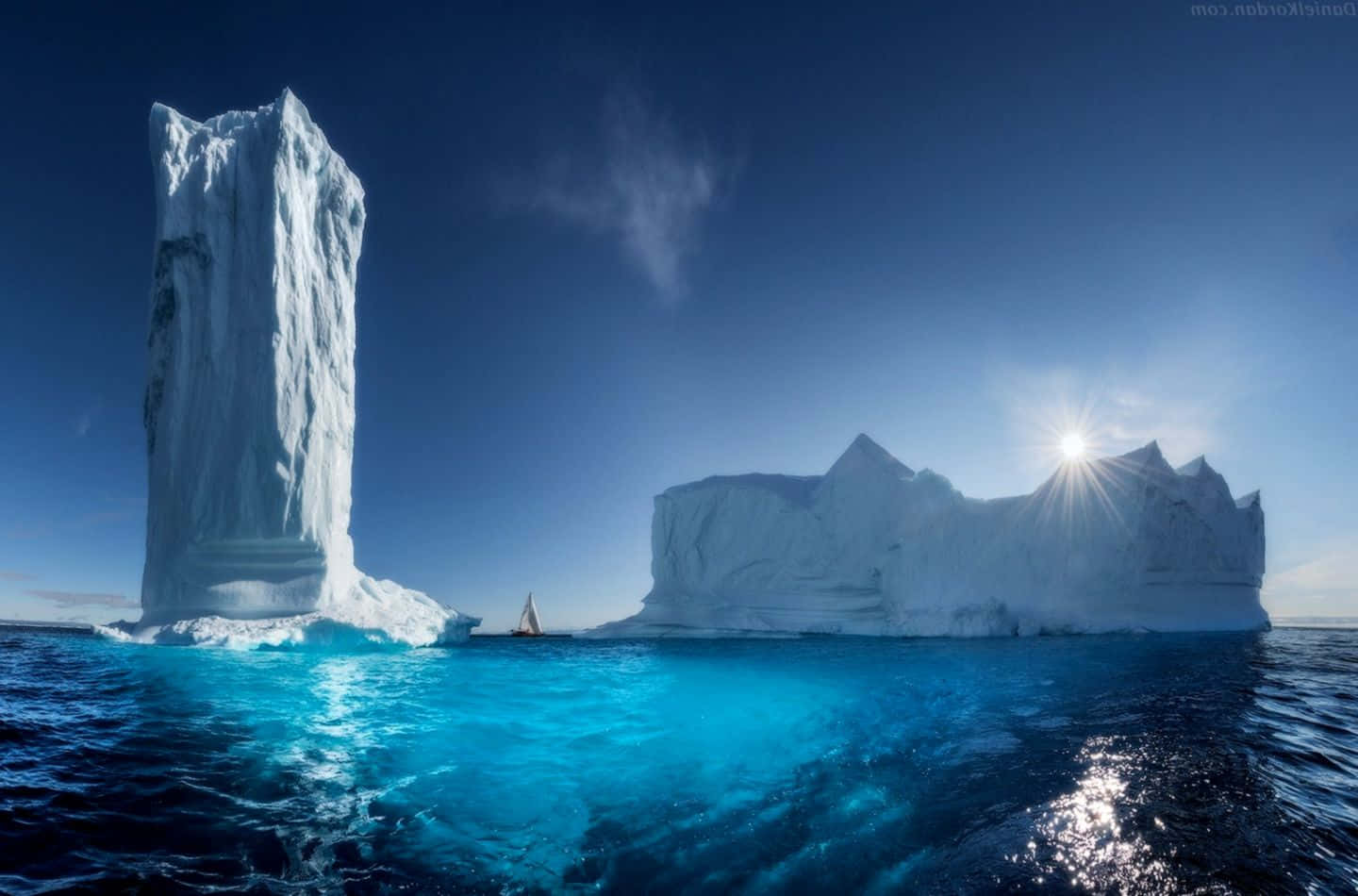 Majestic Iceberg floating in calm ocean waters Wallpaper