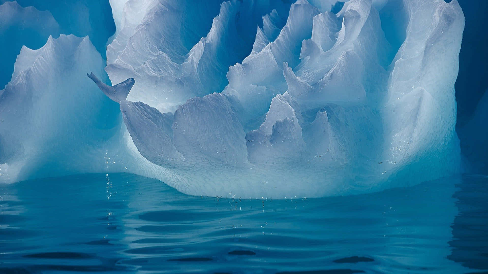 Majestic Iceberg on Turbulent Ocean Wallpaper