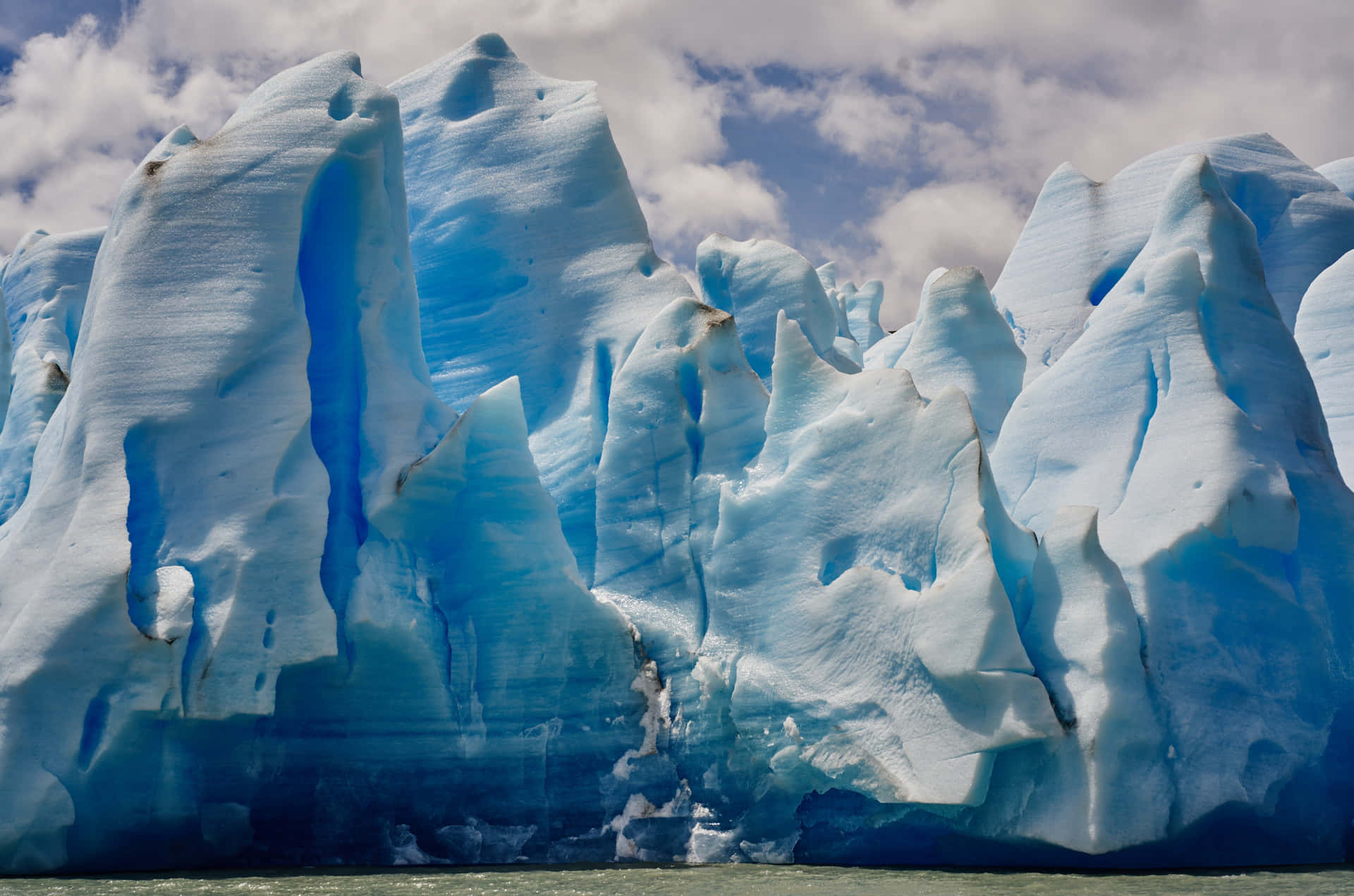 Majestic Iceberg Floating in Pristine Blue Waters Wallpaper