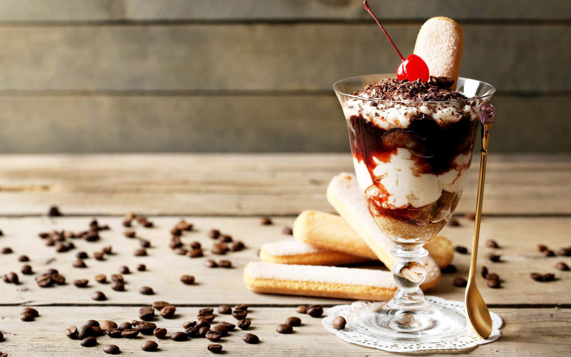 A Glass Of Ice Cream With Chocolate And Cherries