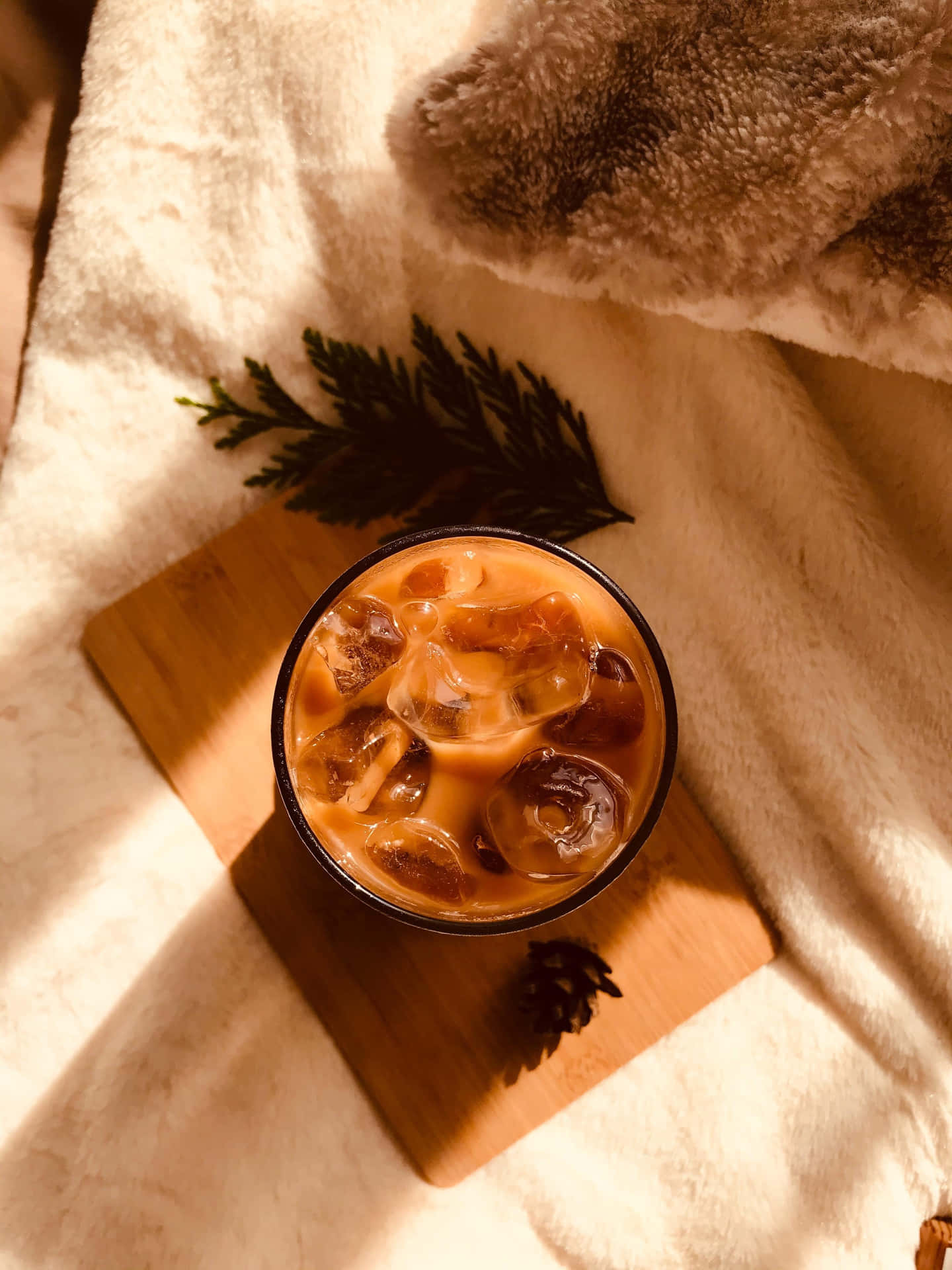 A Cup Of Coffee On A Wooden Board With A Furry Blanket