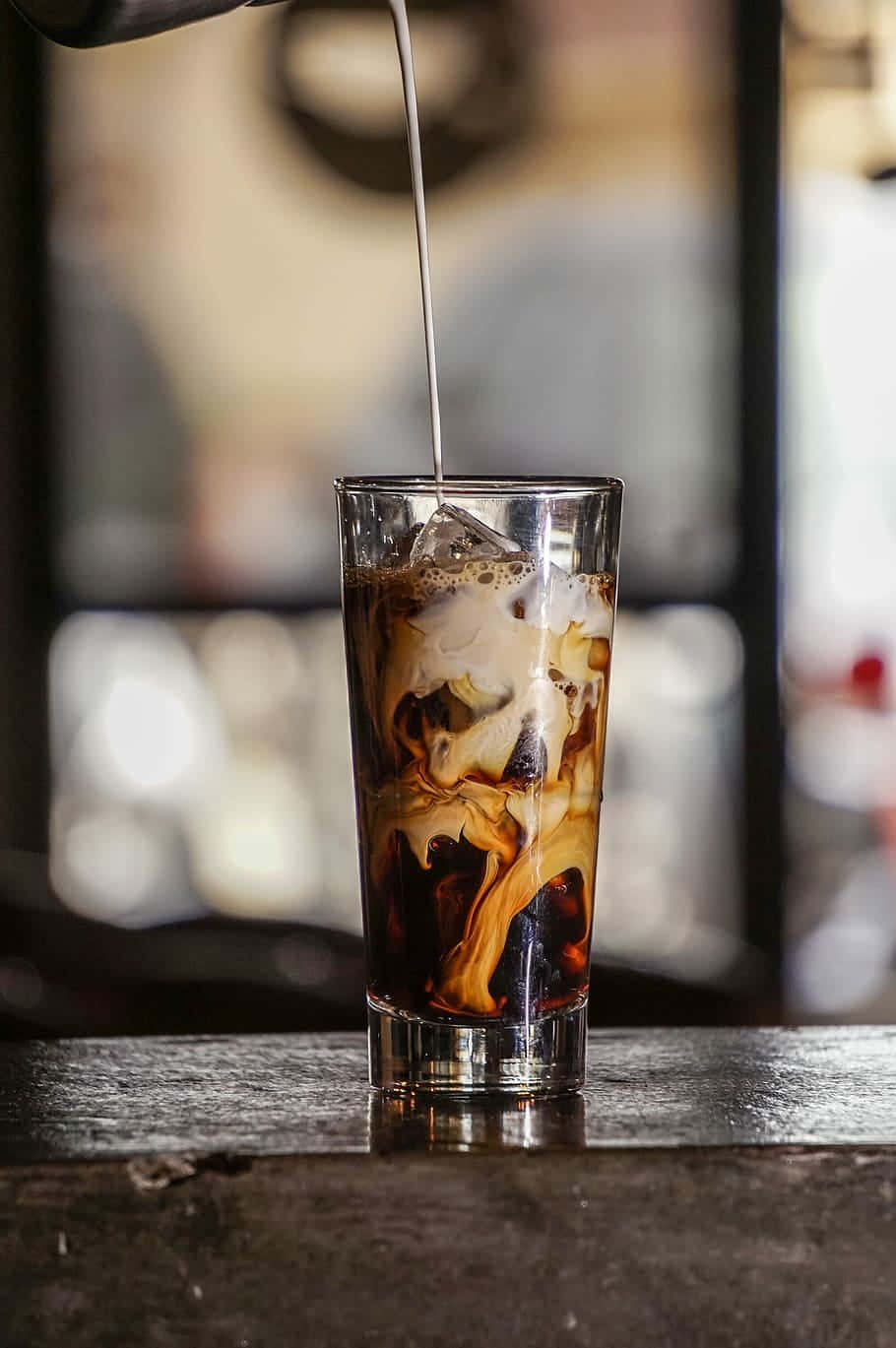 A Glass Of Iced Coffee Being Poured Into A Glass