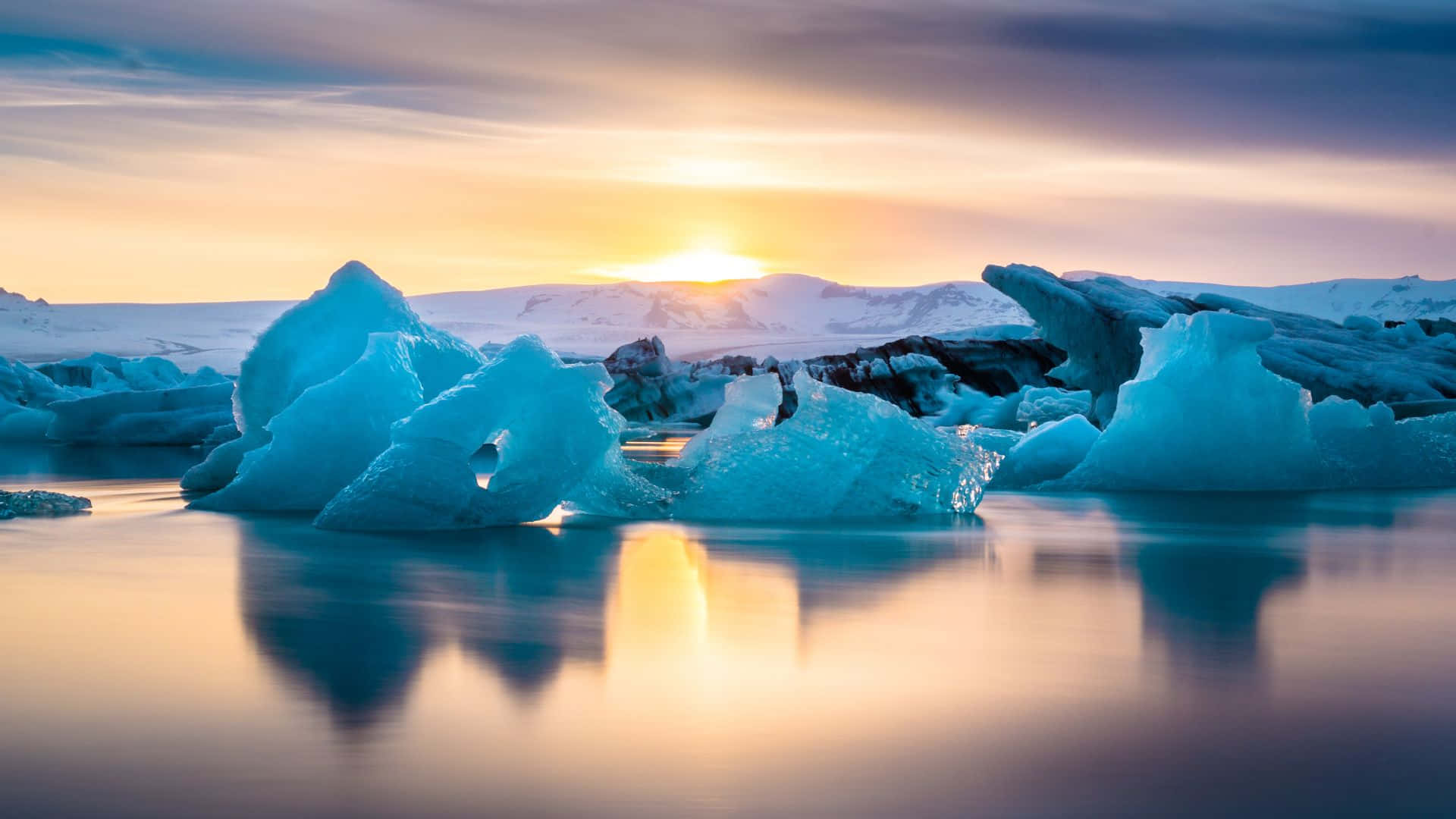 Icebergs In The Water At Sunset