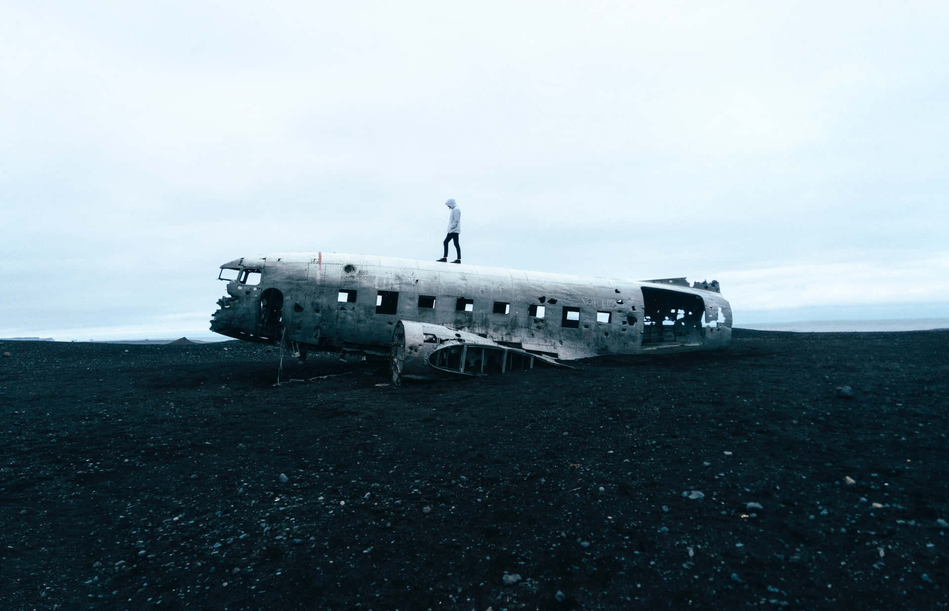 A Man Standing On Top Of An Old Airplane