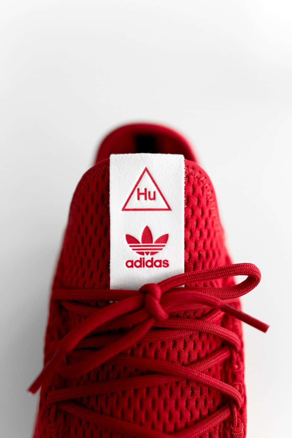 Iconic Adidas Logo On A Striking Red Background