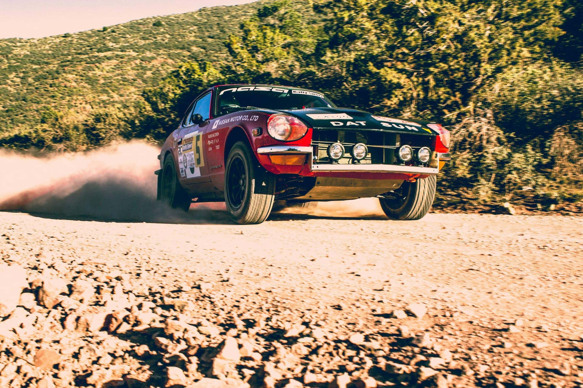 Iconic Datsun 240z In A Scenic Drive Wallpaper