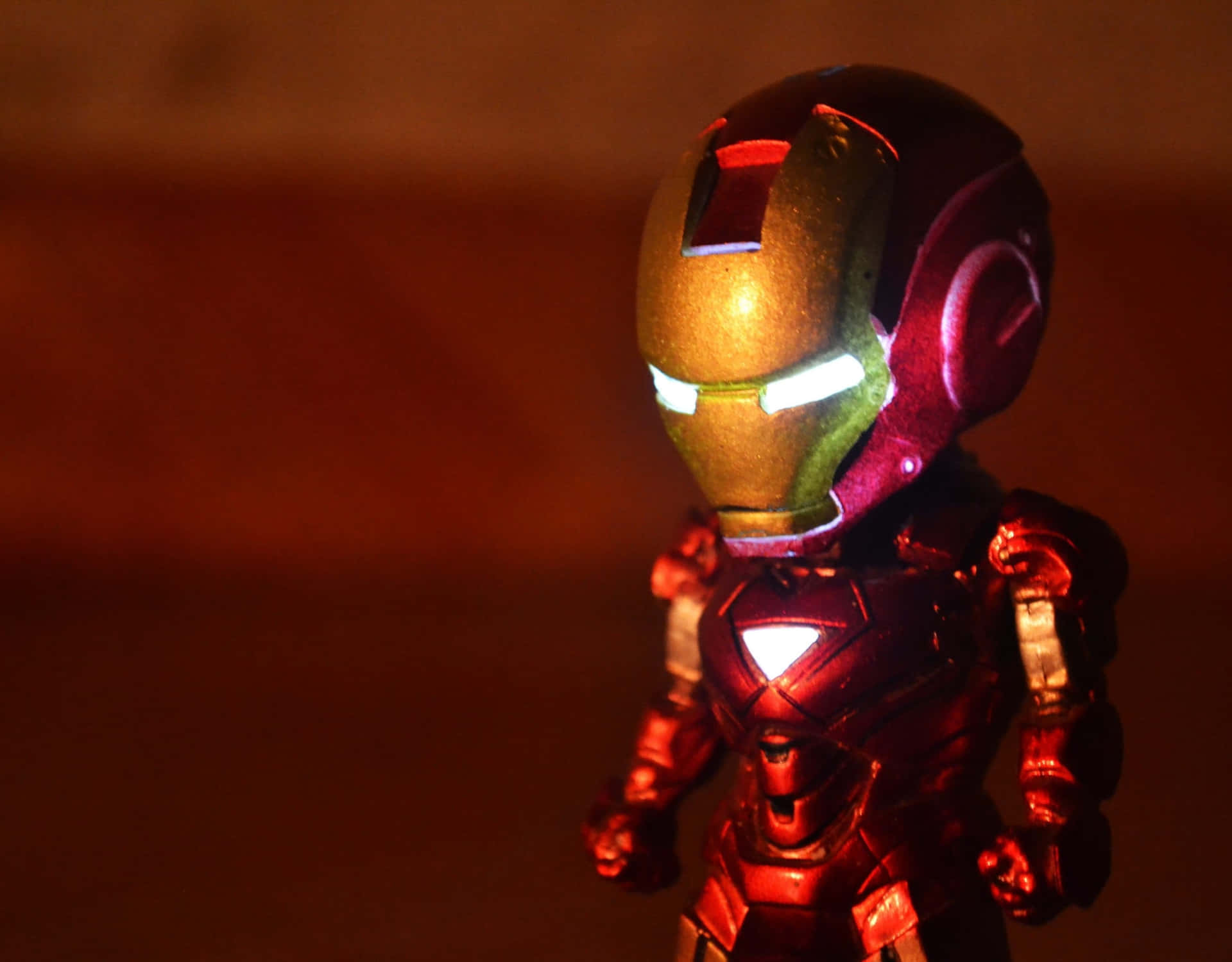 Iconic Iron Man Action Figure In Dynamic Battle Pose Wallpaper