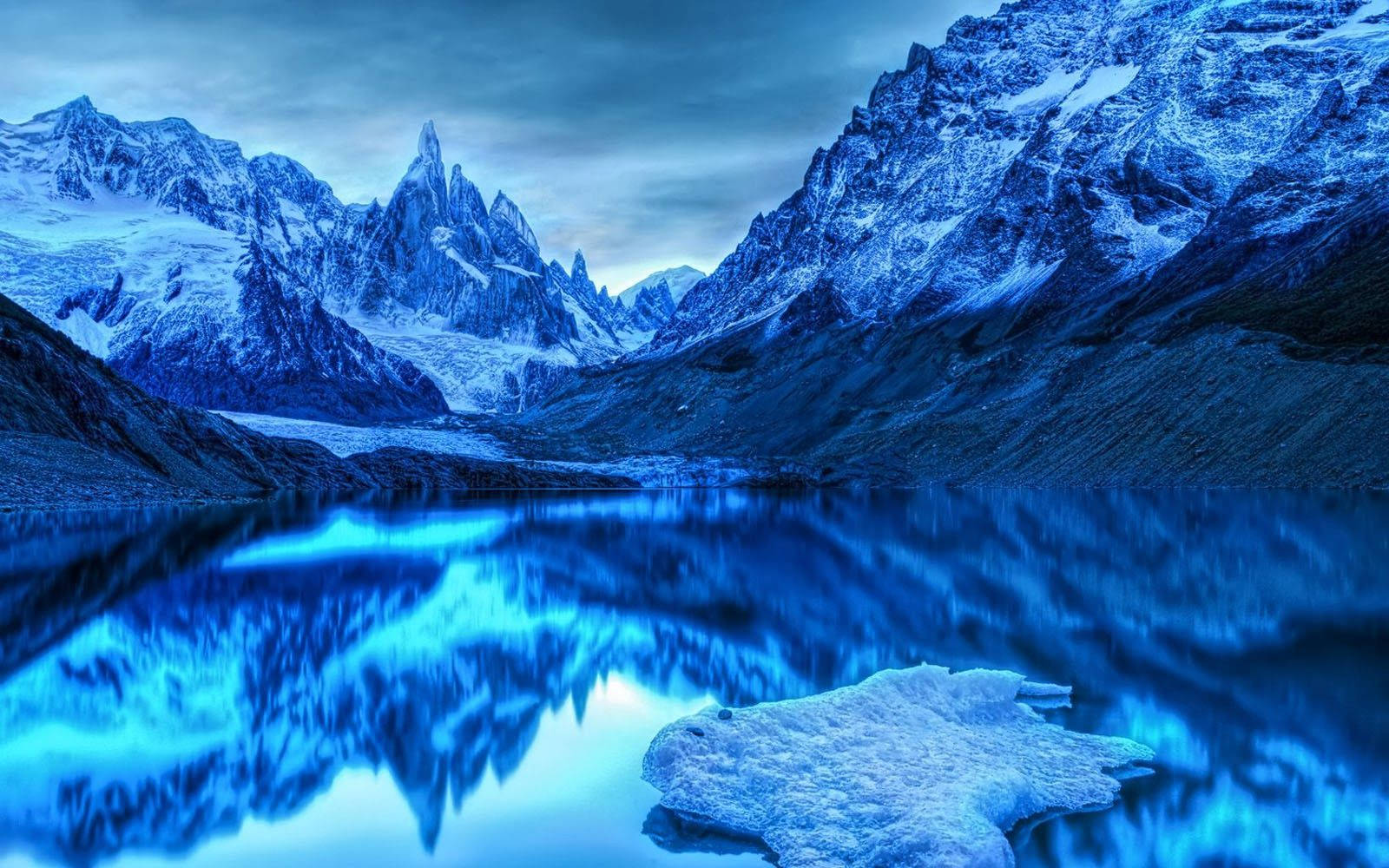 A stunning icy scene of the snowy mountains in winter Wallpaper