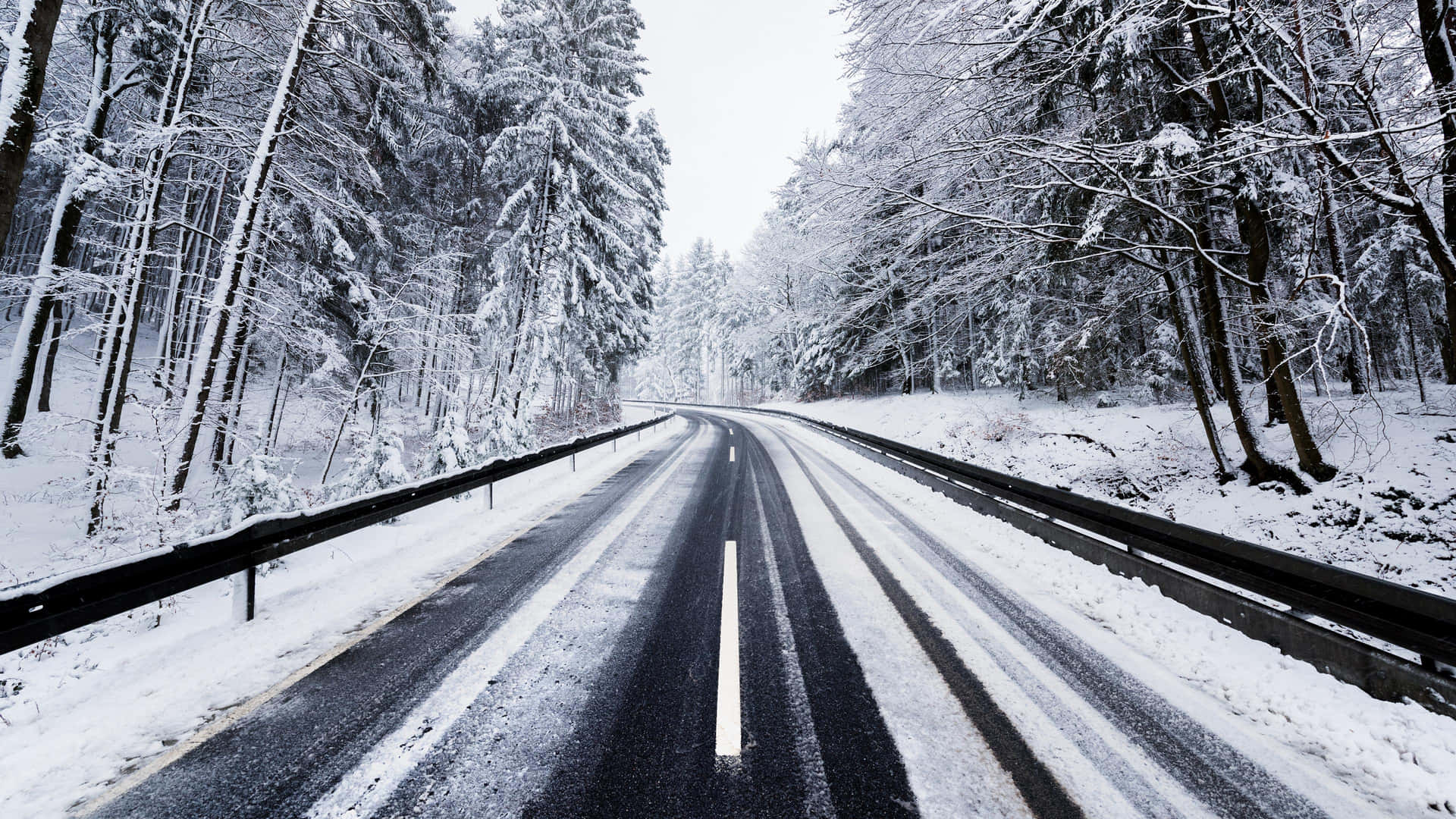 Winter Wonderland - A Snow-Covered Icy Road Wallpaper