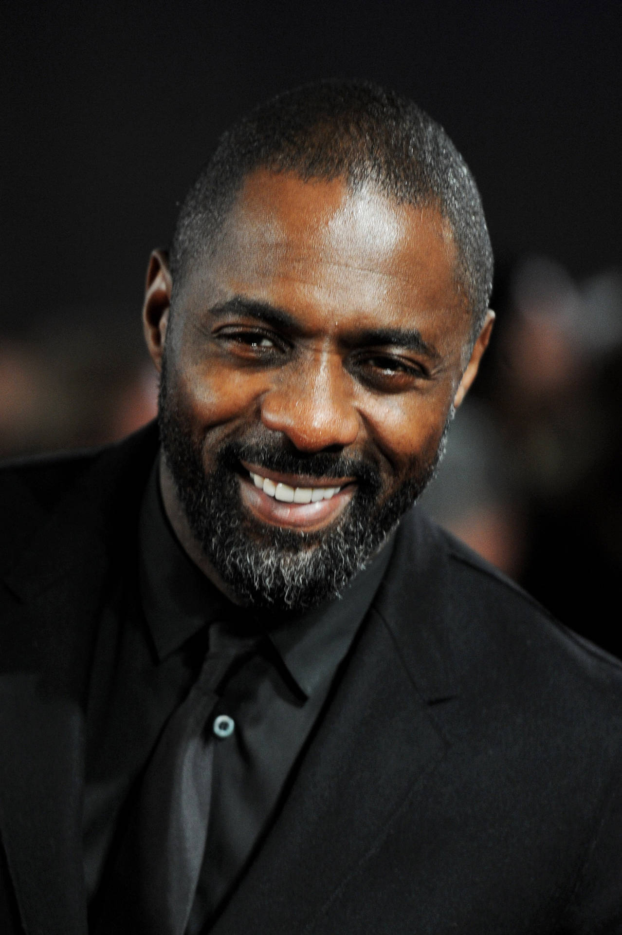 Idris Elba Against Blurry Dark Backdrop Wallpaper