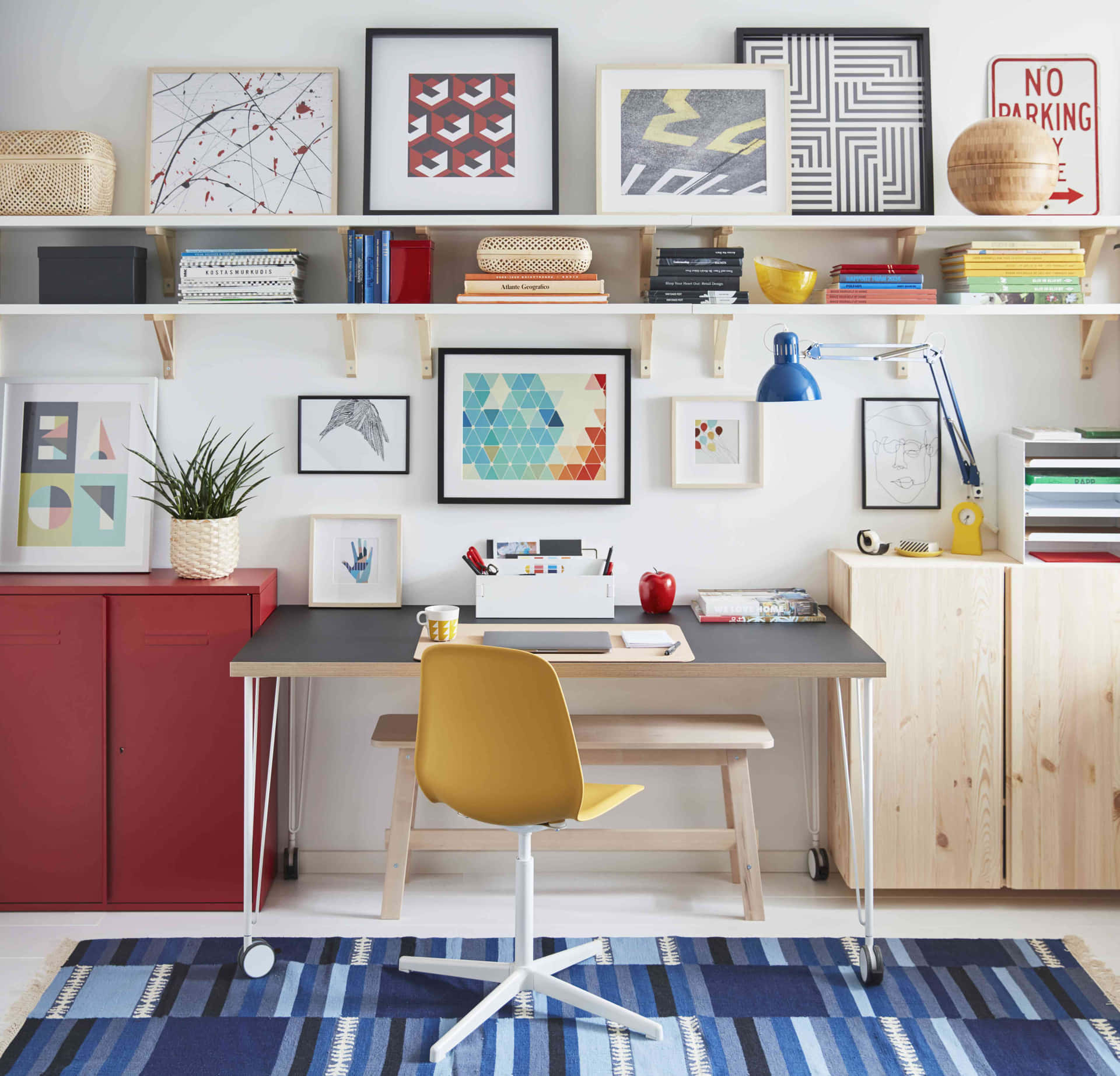 A Home Office With A Desk, Shelves And A Rug